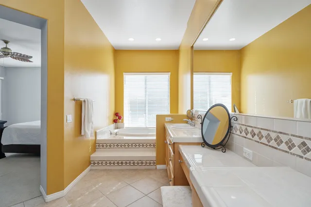 a spacious bedroom with a bed and a window