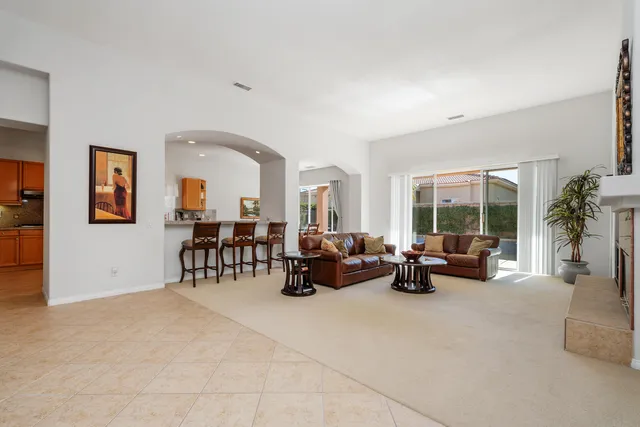 a living room with furniture and large windows