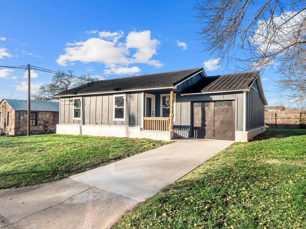 a front view of a house with a garden