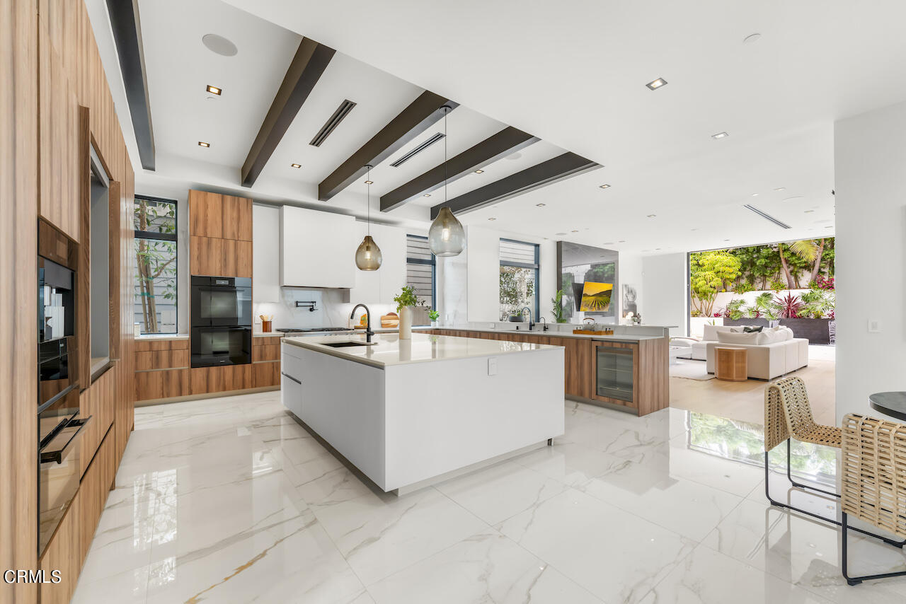 868 9th Street Manhattan Beach, CA 90266 - Photo 11 of 46 a large white kitchen with kitchen island granite countertop lots of counter top space