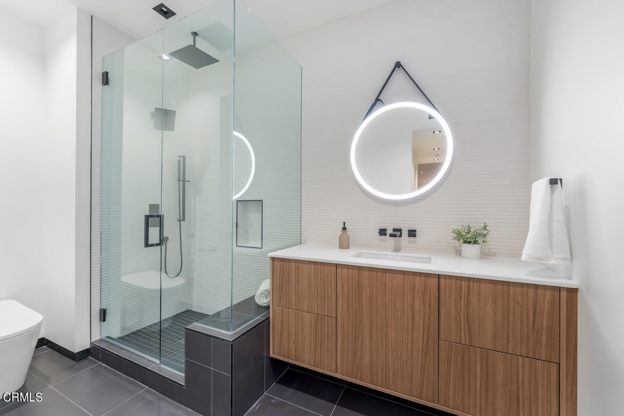 868 9th Street Manhattan Beach, CA 90266 - Photo 41 of 46 a bathroom with a sink and mirror