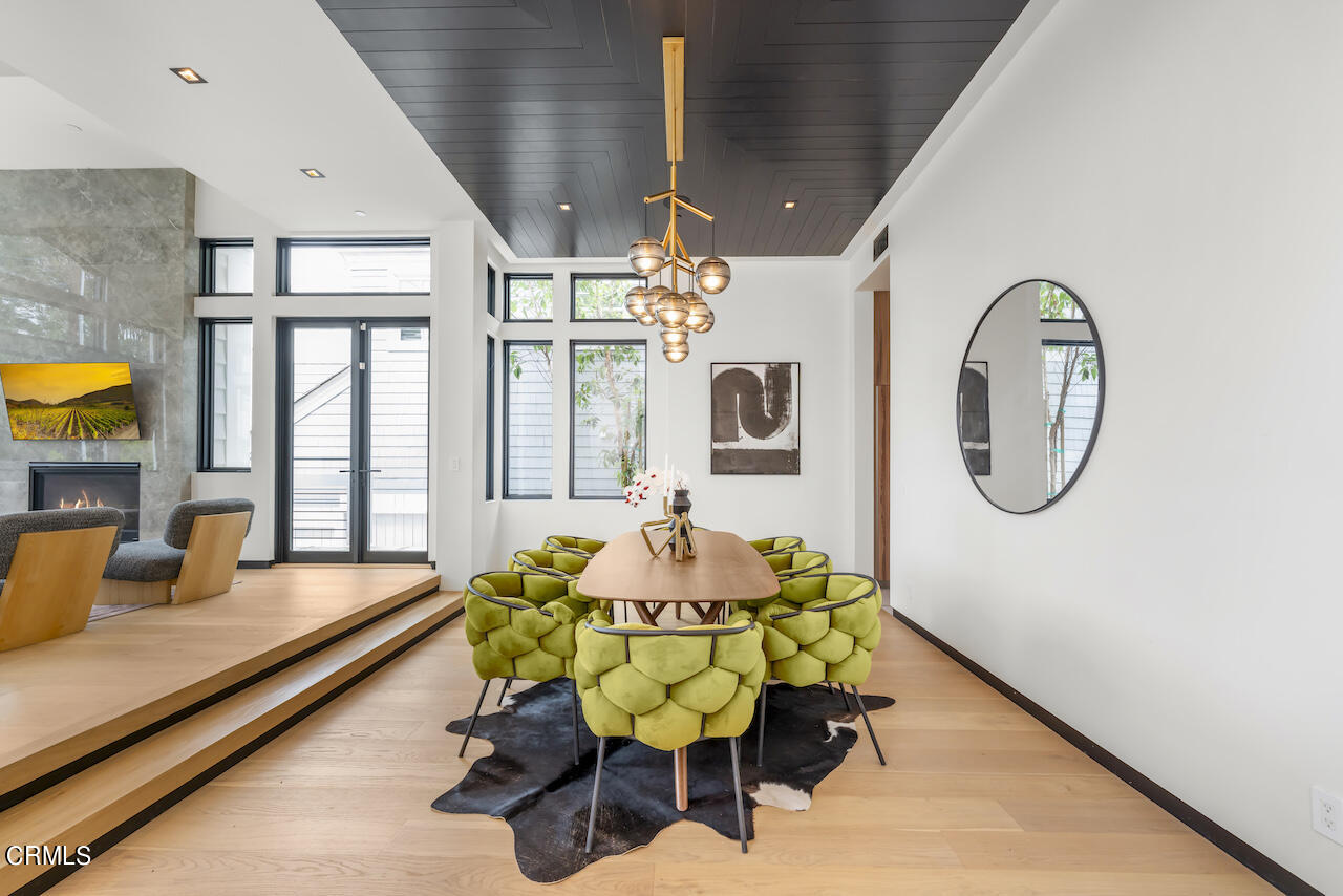 868 9th Street Manhattan Beach, CA 90266 - Photo 6 of 46 a dining room with furniture and a chandelier