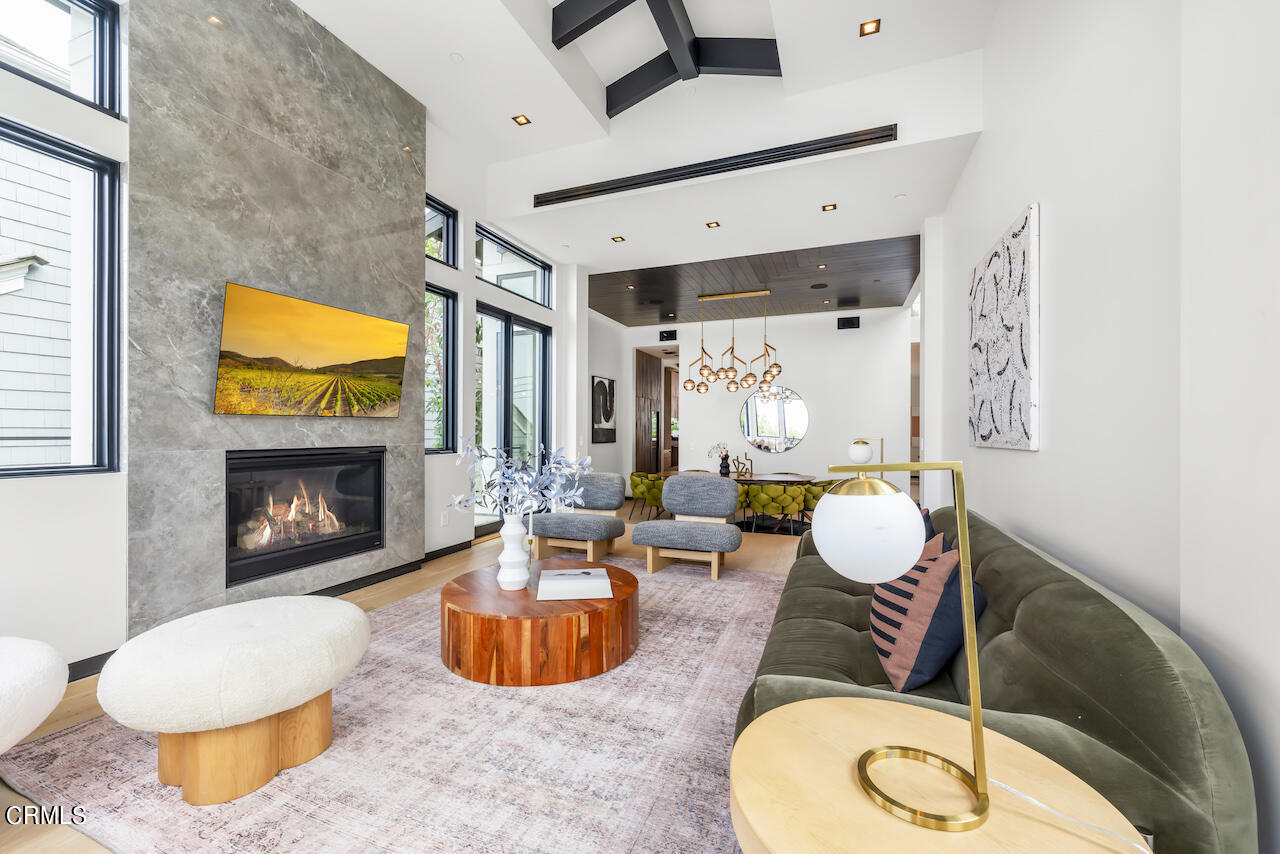 868 9th Street Manhattan Beach, CA 90266 - Photo 8 of 46 a living room with furniture a fireplace and a flat screen tv