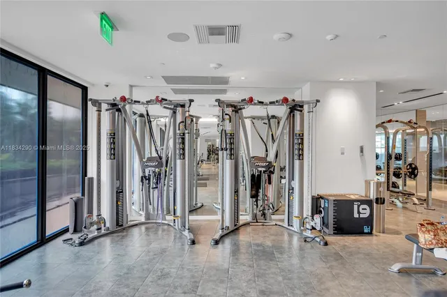 a view of a livingroom with furniture and floor to ceiling window