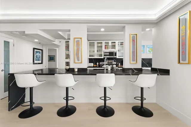 a large kitchen with a sink and stainless steel appliances