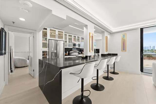 a kitchen with stainless steel appliances granite countertop a sink and stove