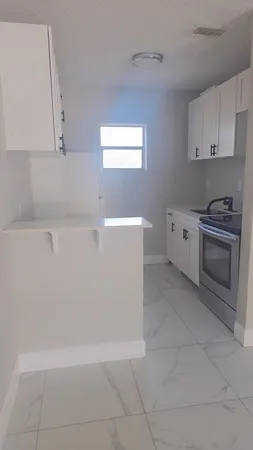 a view of a kitchen with electric appliances