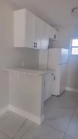 a view of cabinets and window in white room