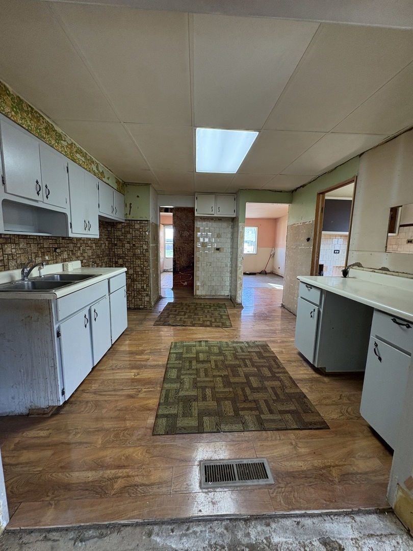 17226 Community Street Lansing, IL 60438 - Photo 15 of 24 a living room with stainless steel appliances granite countertop furniture wooden floor and a view of kitchen