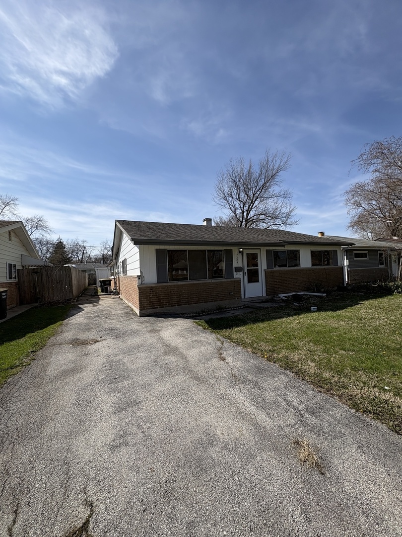 17226 Community Street Lansing, IL 60438 - Photo 2 of 24 a front view of a house with a yard