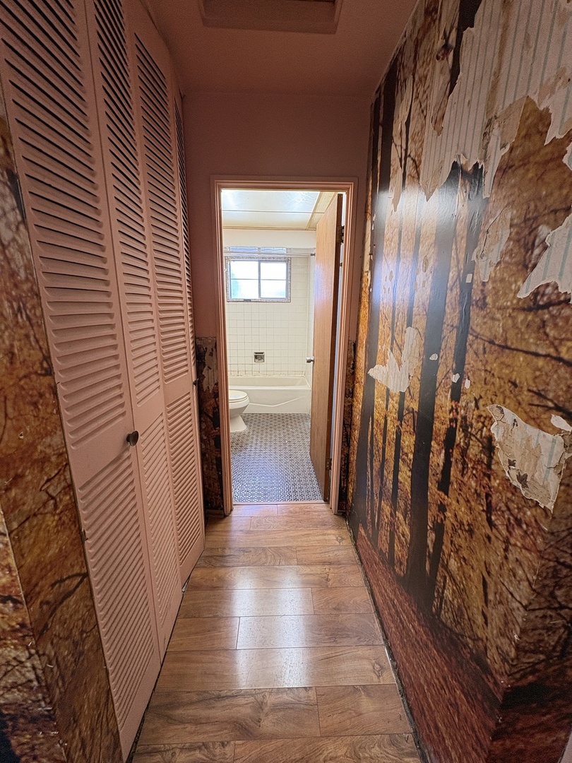 17226 Community Street Lansing, IL 60438 - Photo 6 of 24 a view of a hallway with wooden floor and staircase