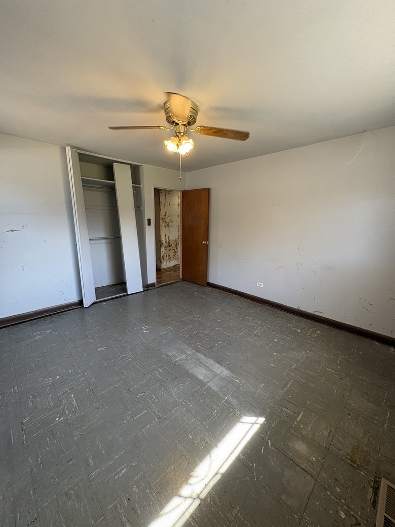 17226 Community Street Lansing, IL 60438 - Photo 9 of 24 a view of a livingroom with a ceiling fan and window