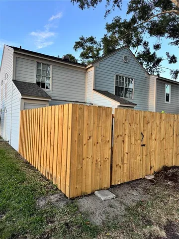 a view of a house with wooden fence