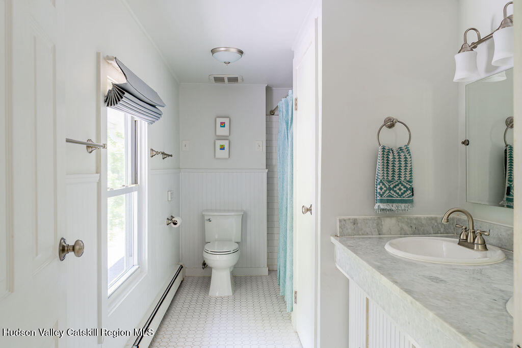 347 Hickory Bush Road Kingston, NY 12401 - Photo 23 of 44 a bathroom with a granite countertop sink toilet and shower a mirror