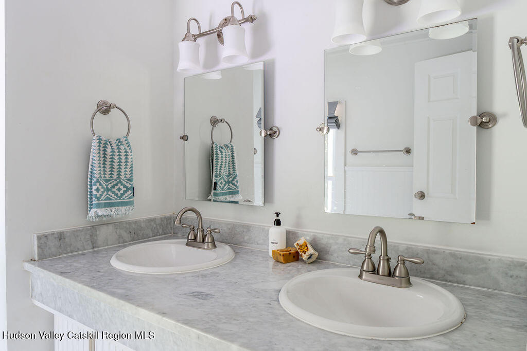 347 Hickory Bush Road Kingston, NY 12401 - Photo 24 of 44 a bathroom with double vanity sinks and a mirror