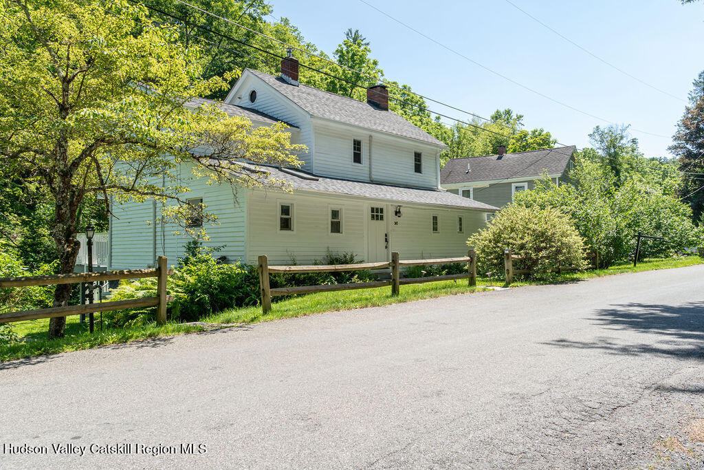 347 Hickory Bush Road Kingston, NY 12401 - Photo 44 of 44 a view of a white house with a yard and plants