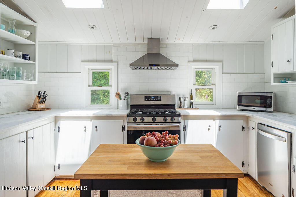 347 Hickory Bush Road Kingston, NY 12401 - Photo 6 of 44 a kitchen with a stove a microwave and wooden cabinets