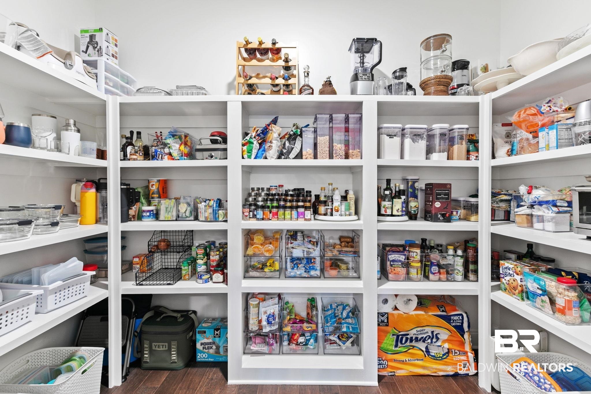13233 Ibis Boulevard Daphne, AL 36527 - Photo 21 of 100 Expansive pantry featuring extensive white built-in shelving, rich wood-finish flooring, and bright overhead lighting