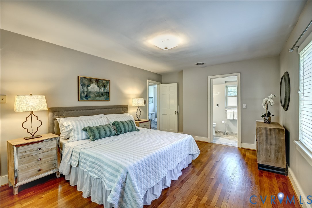 4814 Riverside Drive Richmond, VA 23225 - Photo 23 of 39 a spacious bedroom with a bed and wooden floor