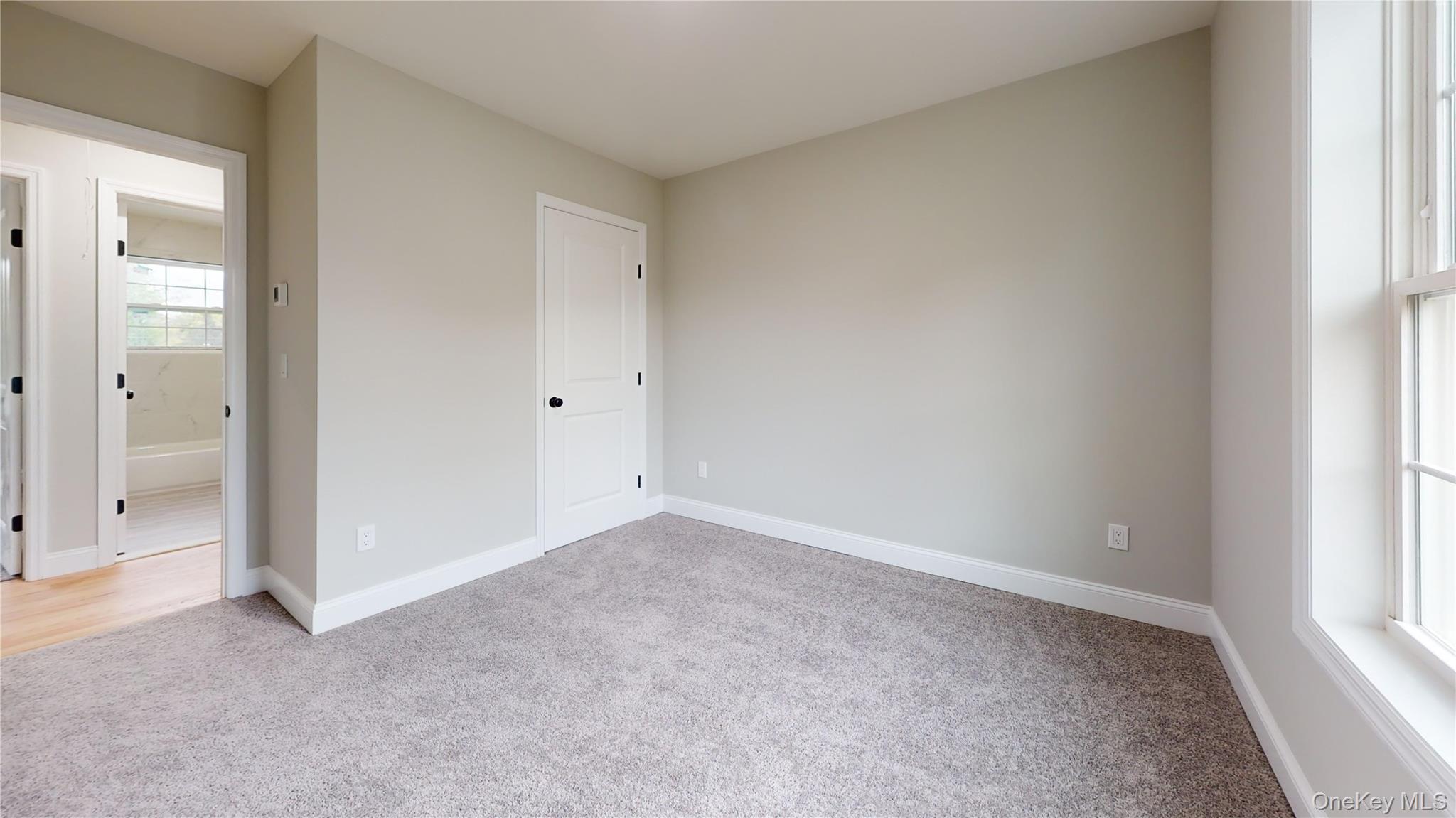 492 Blue Point Road Farmingville, NY 11738 - Photo 11 of 21 an empty room with windows and closet