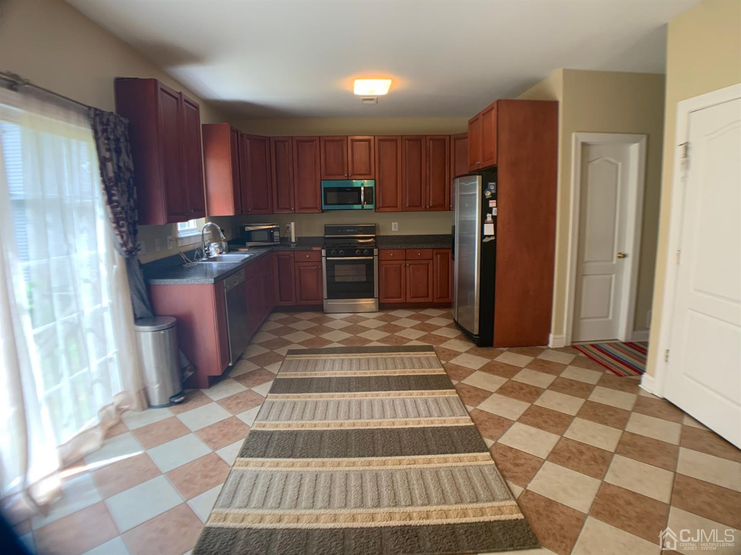 710 Spruce Road North Brunswick, NJ 08902 - Photo 14 of 28 a kitchen with stainless steel appliances granite countertop a refrigerator and a sink