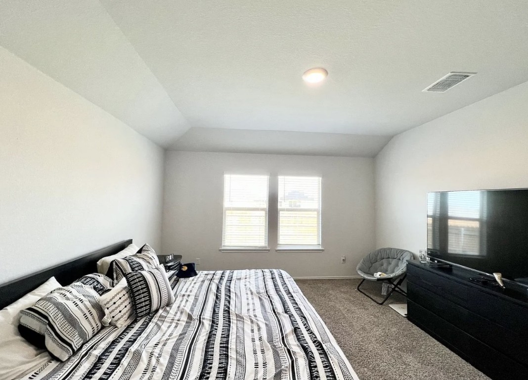 544 Taggart Trail Jarrell, TX 76537 - Photo 8 of 19 a bedroom with bed and a flat screen tv