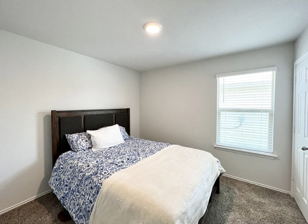 544 Taggart Trail Jarrell, TX 76537 - Photo 10 of 19 a bedroom with a large bed and a window