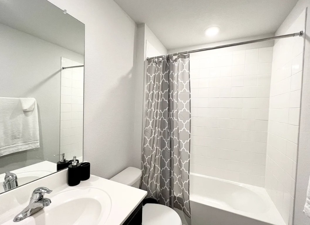 544 Taggart Trail Jarrell, TX 76537 - Photo 11 of 19 a bathroom with a bathtub a sink and a shower