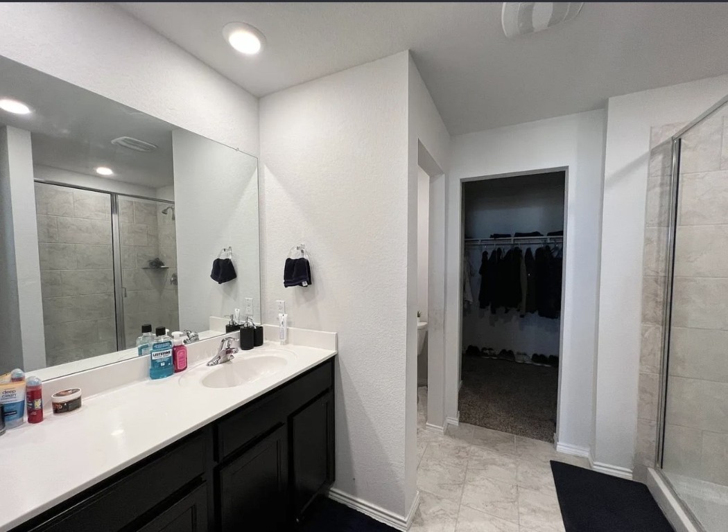 544 Taggart Trail Jarrell, TX 76537 - Photo 6 of 19 a en suite bathroom with a sink shower and a mirror