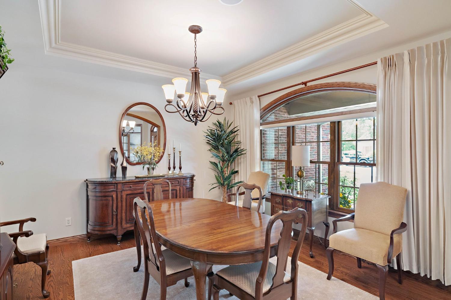 770 Quinlan Court Crown Point, IN 46307 - Photo 12 of 53 a view of a dining room with furniture a chandelier and wooden floor