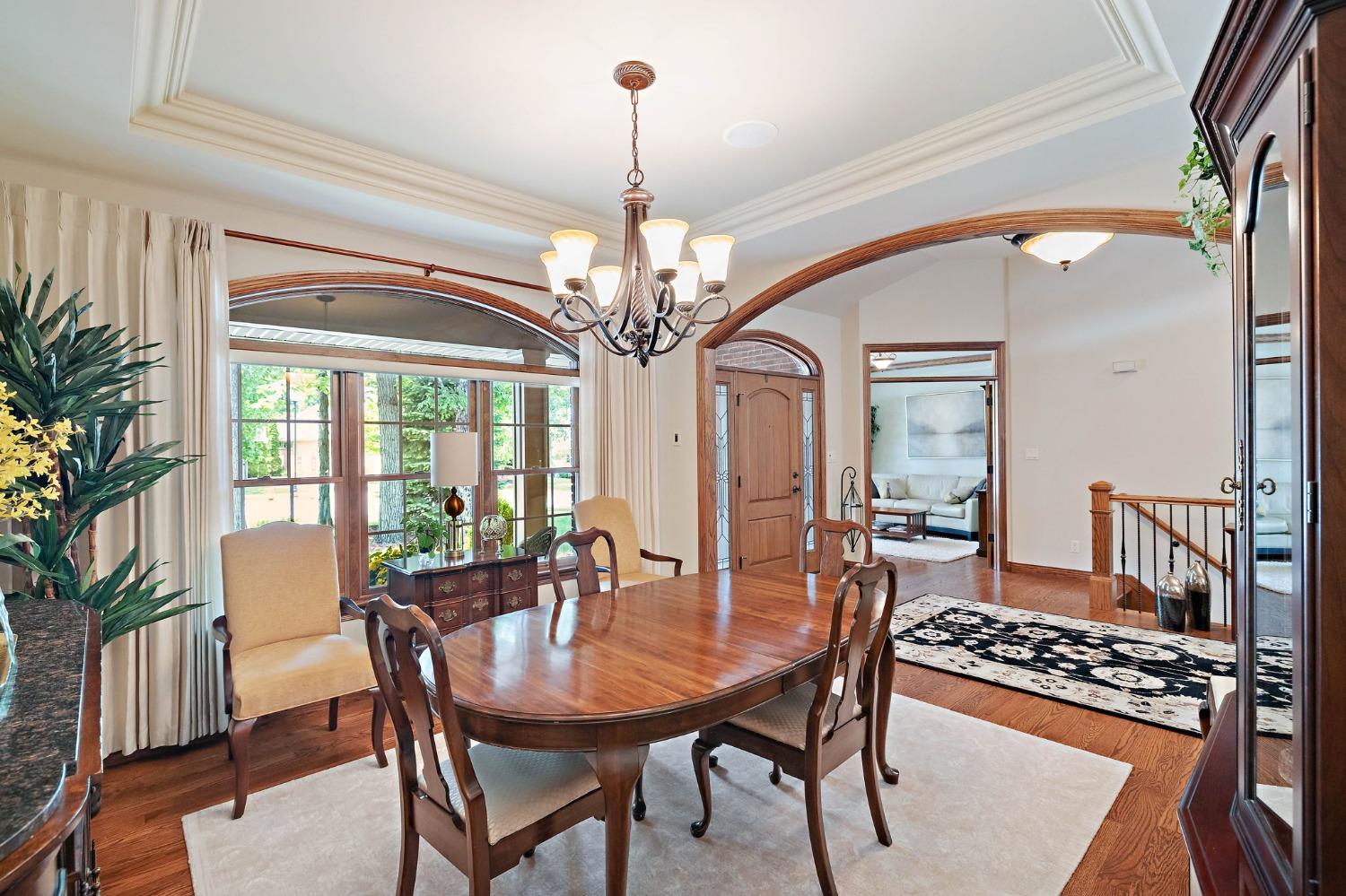 770 Quinlan Court Crown Point, IN 46307 - Photo 13 of 53 a view of a dining room with furniture window and wooden floor