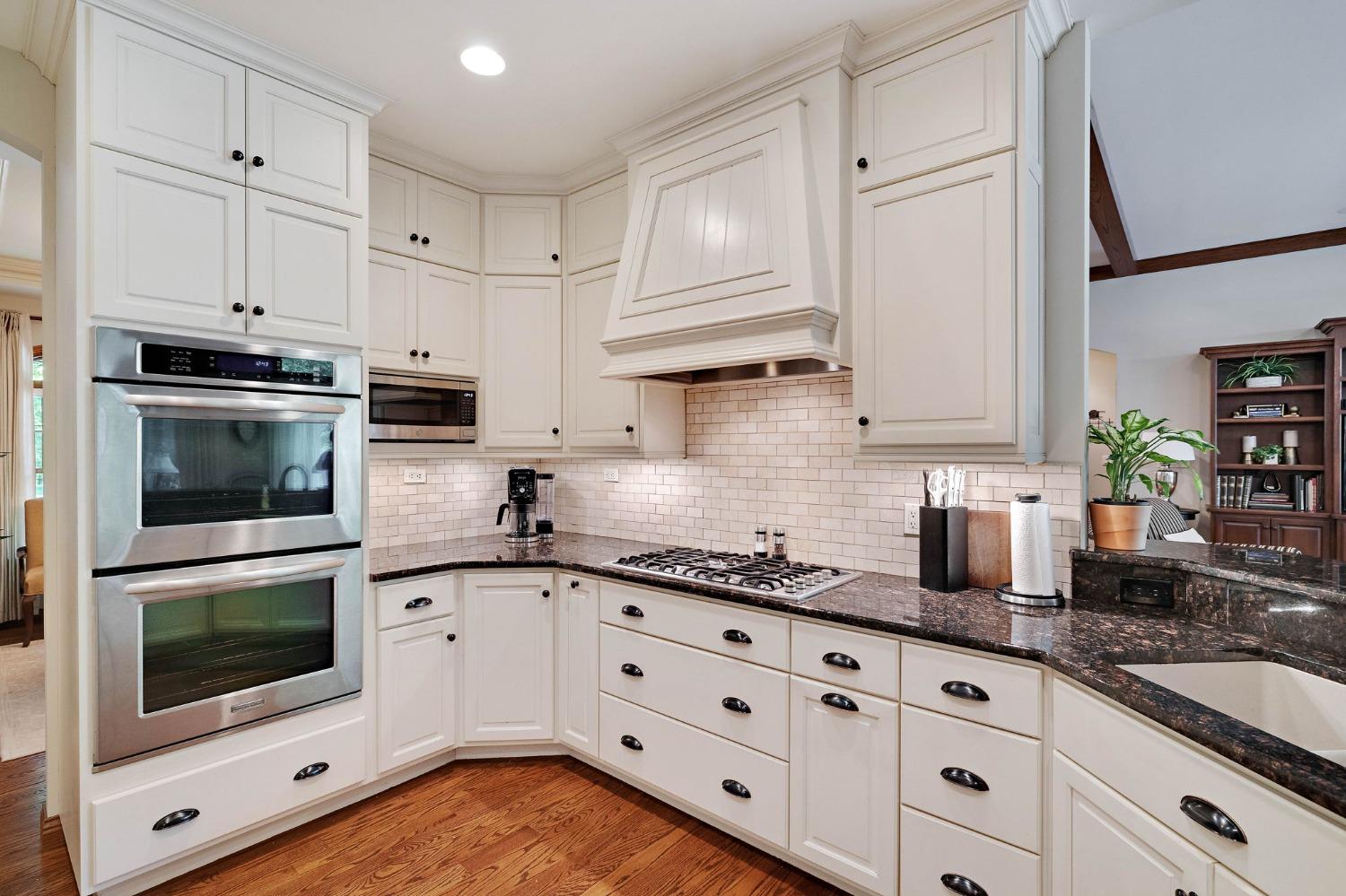 770 Quinlan Court Crown Point, IN 46307 - Photo 21 of 53 a kitchen with granite countertop white cabinets stainless steel appliances and sink