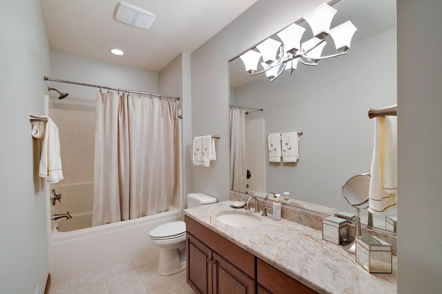 770 Quinlan Court Crown Point, IN 46307 - Photo 32 of 53 a bathroom with a granite countertop sink a toilet and a mirror