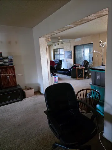 a living room with furniture a window and a flat screen tv