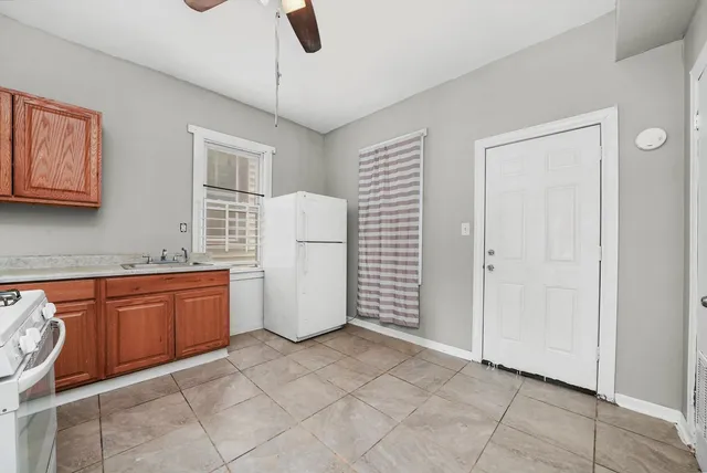 a kitchen with granite countertop a sink a counter space and cabinets