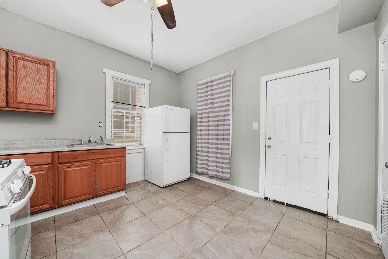 5014 South Paulina Street Chicago, IL 60609 - Photo 13 of 38 a kitchen with granite countertop a sink a counter space and cabinets