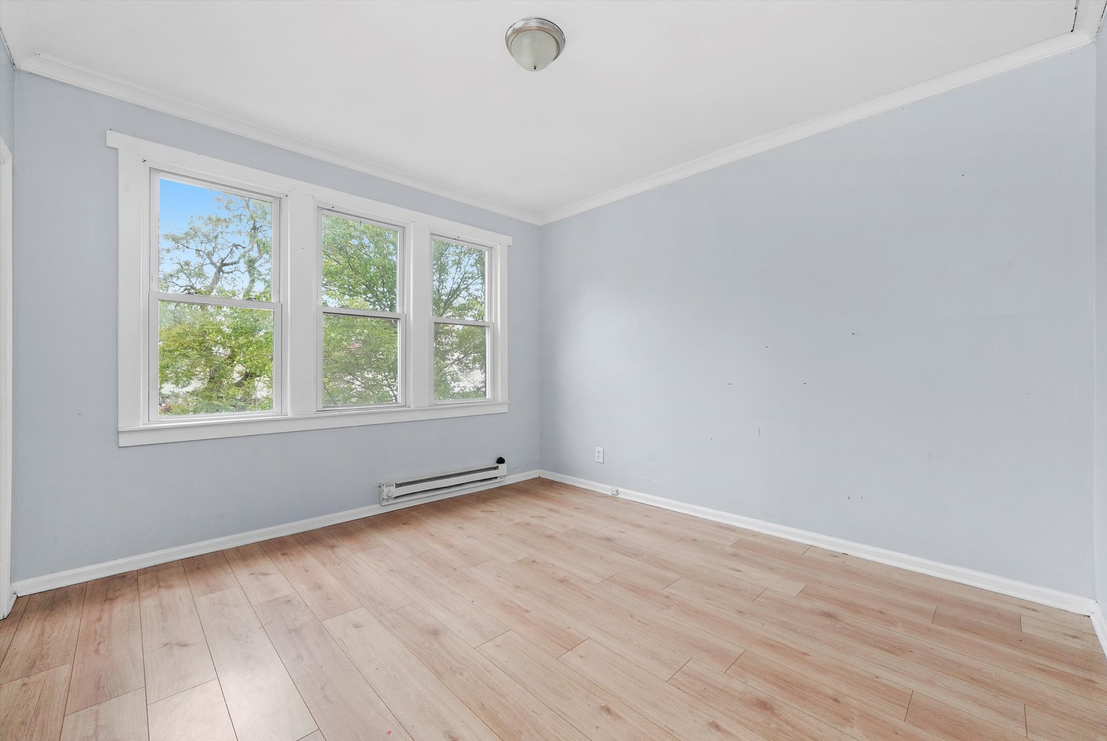 5014 South Paulina Street Chicago, IL 60609 - Photo 17 of 38 an empty room with wooden floor and windows
