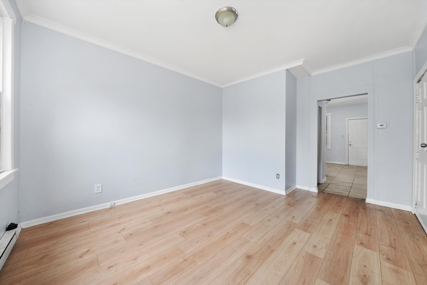 5014 South Paulina Street Chicago, IL 60609 - Photo 18 of 38 a view of an empty room with wooden floor