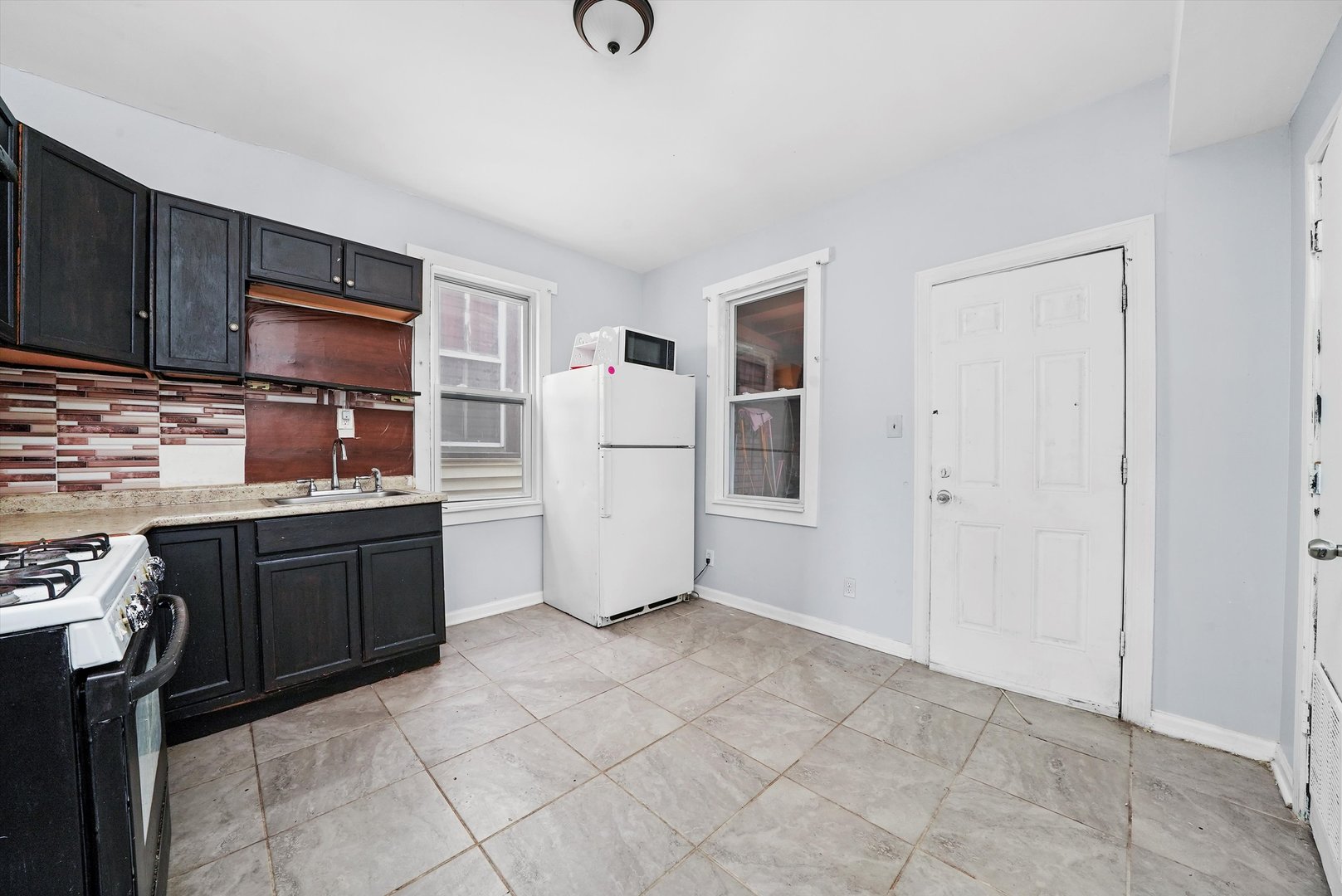 5014 South Paulina Street Chicago, IL 60609 - Photo 21 of 38 a kitchen with stainless steel appliances a refrigerator and cabinets