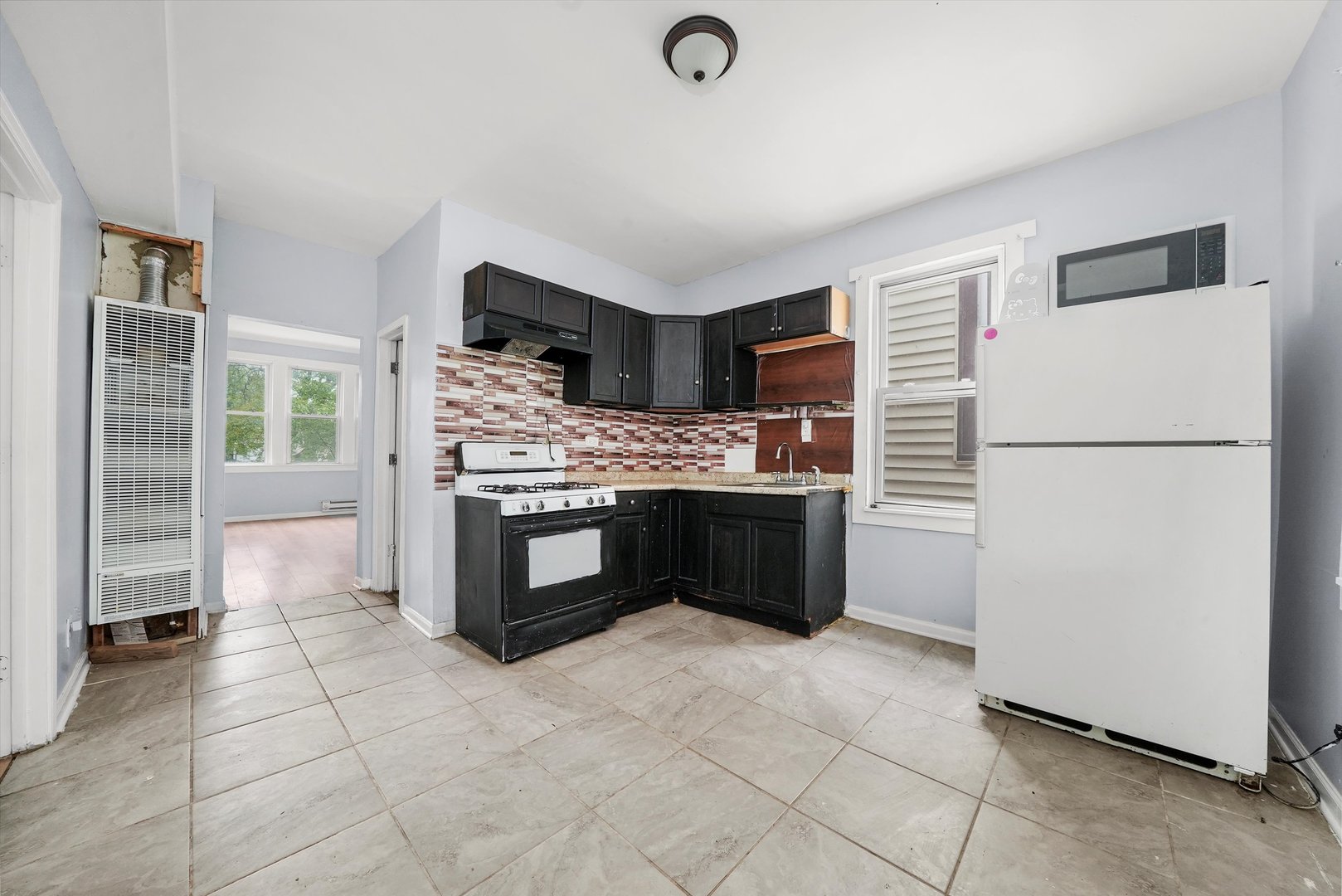 5014 South Paulina Street Chicago, IL 60609 - Photo 22 of 38 a kitchen with stainless steel appliances a stove a refrigerator and a sink