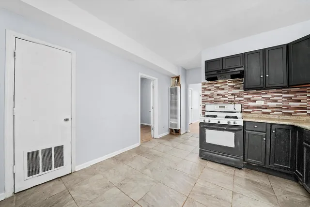 a kitchen with stainless steel appliances granite countertop a stove and a sink