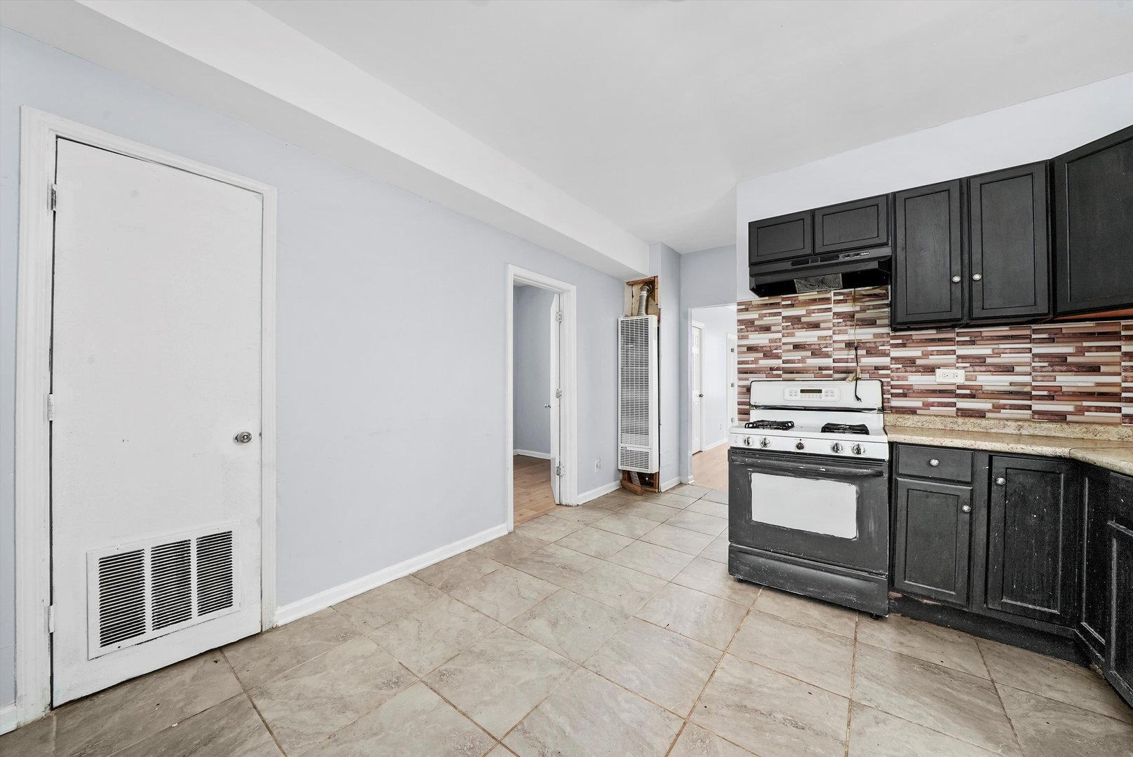 5014 South Paulina Street Chicago, IL 60609 - Photo 23 of 38 a kitchen with stainless steel appliances granite countertop a stove and a sink