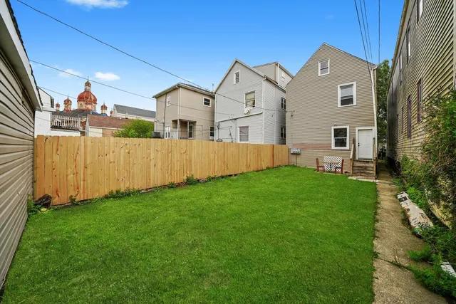 a front view of a house with a garden and yard