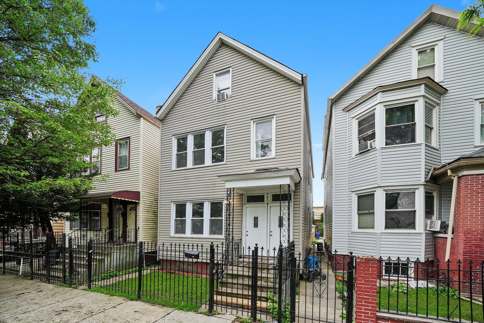 5014 South Paulina Street Chicago, IL 60609 - Photo 4 of 38 a front view of a house with a yard