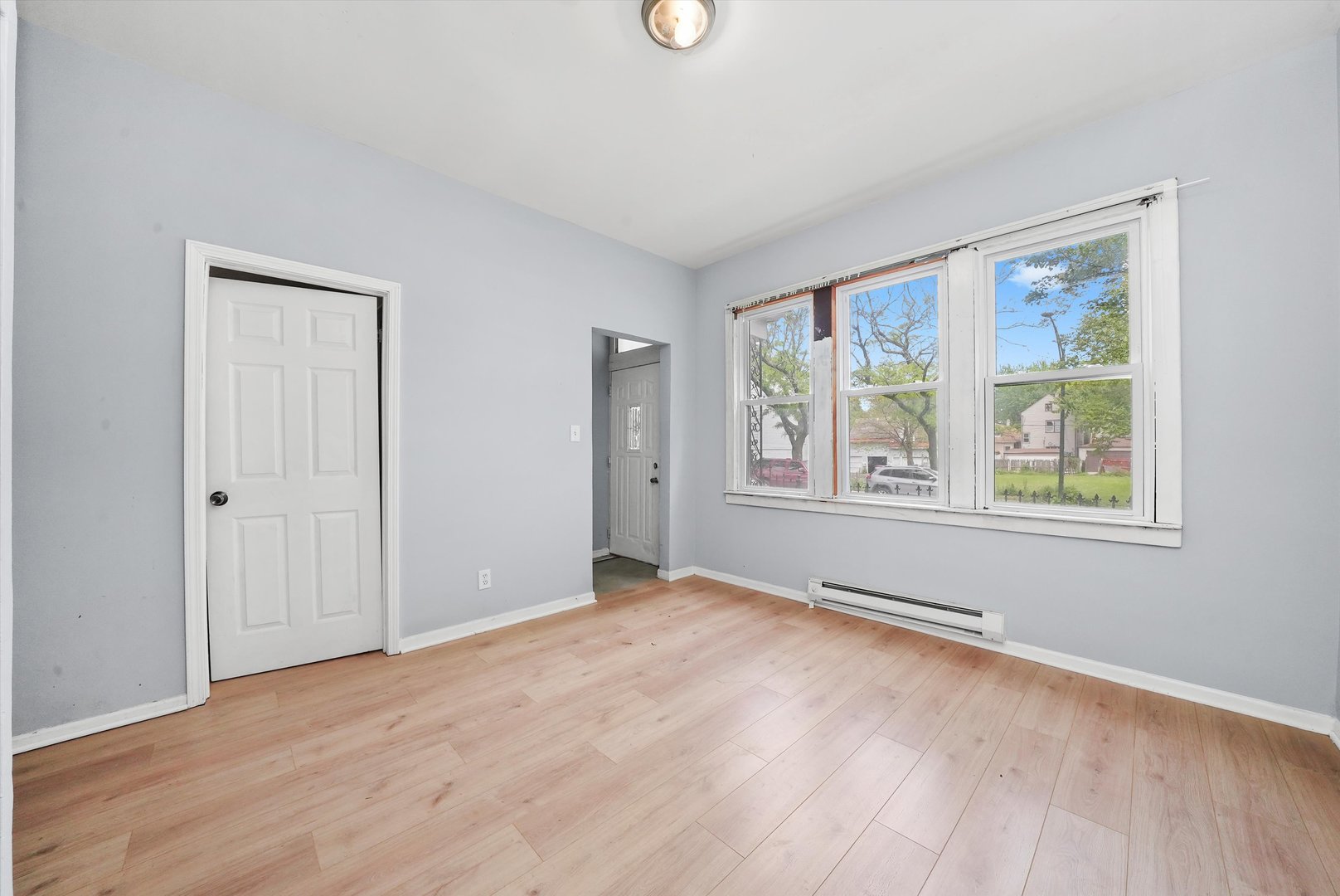 5014 South Paulina Street Chicago, IL 60609 - Photo 9 of 38 a view of an empty room with wooden floor and a window