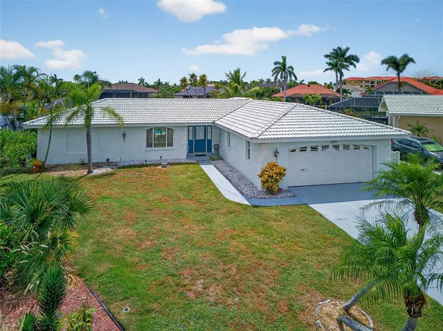 a front view of house with yard and outdoor seating