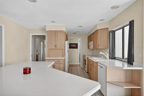 a kitchen with a sink a stove and refrigerator