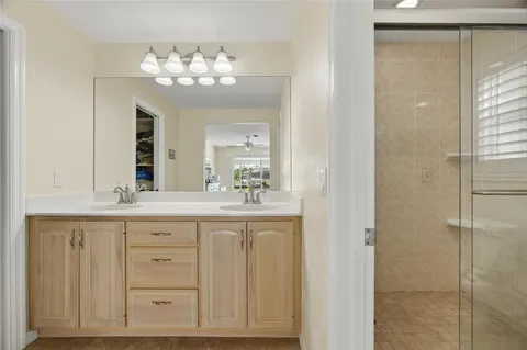 a bathroom with a sink vanity and a mirror
