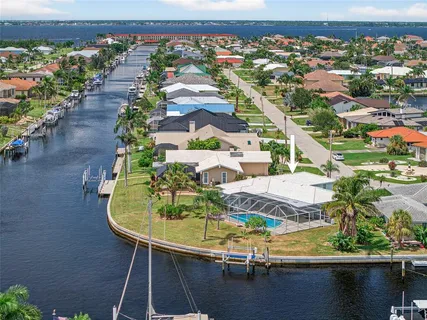 an aerial view of a house with swimming pool patio and outdoor seating