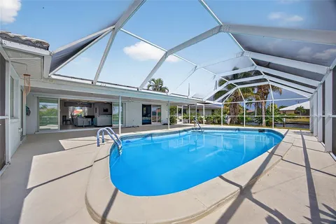 a view of a house with swimming pool and porch
